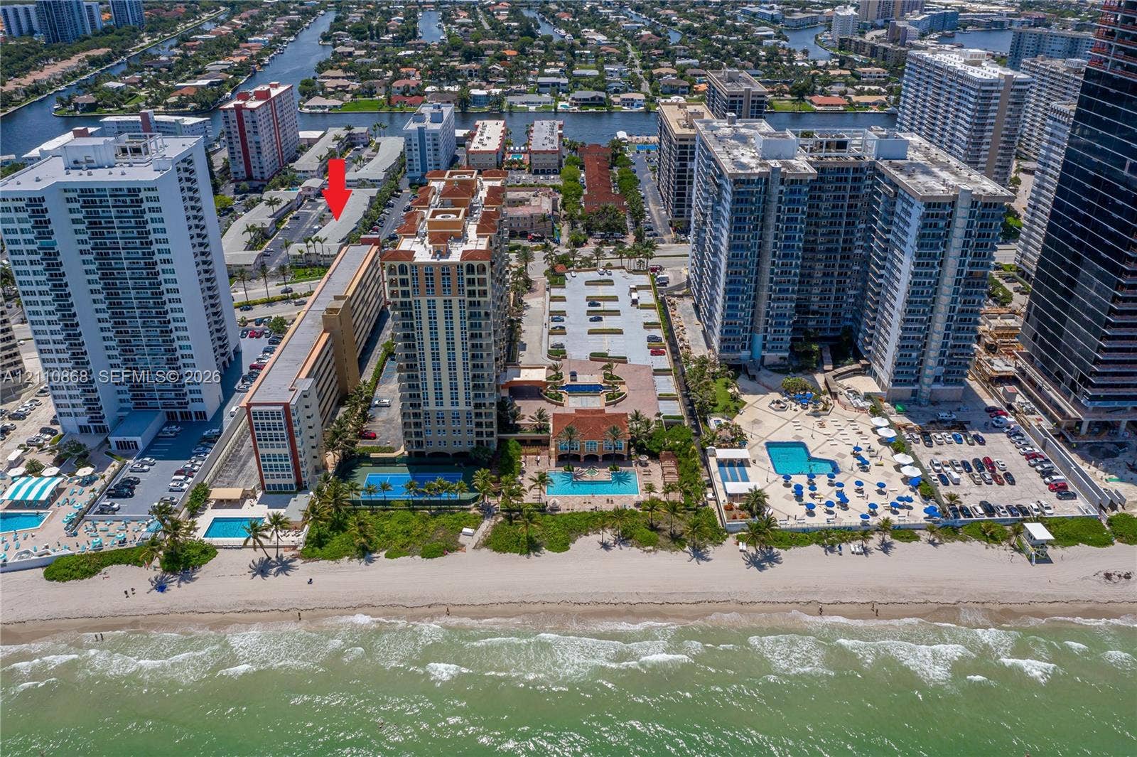 3121 S Ocean Drive, #209, Hallandale Beach, FL 33009 Aerial coastal perspective featuring multiple high-rise residential structures, on-site swimming pools, tennis courts, and direct proximity to the ocean shoreline