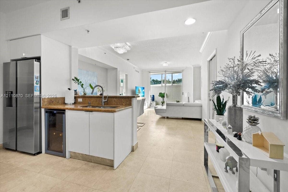 1755 E Hallandale Beach Boulevard, #MEZ5E, Hallandale Beach, FL 33009 Kitchen area featuring stone-finish countertops, stainless steel side-by-side refrigerator, under-counter wine cooler, and tile flooring