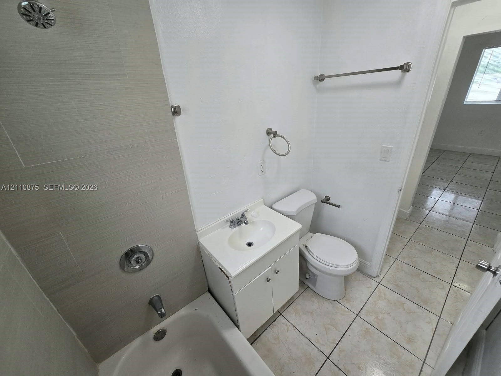535 NW 7th Street, #10, Miami, Miami, FL 33136 Bathroom featuring tile flooring, a tub-shower combination with light-toned wall tile, a white vanity with an integrated sink, and metallic fixtures