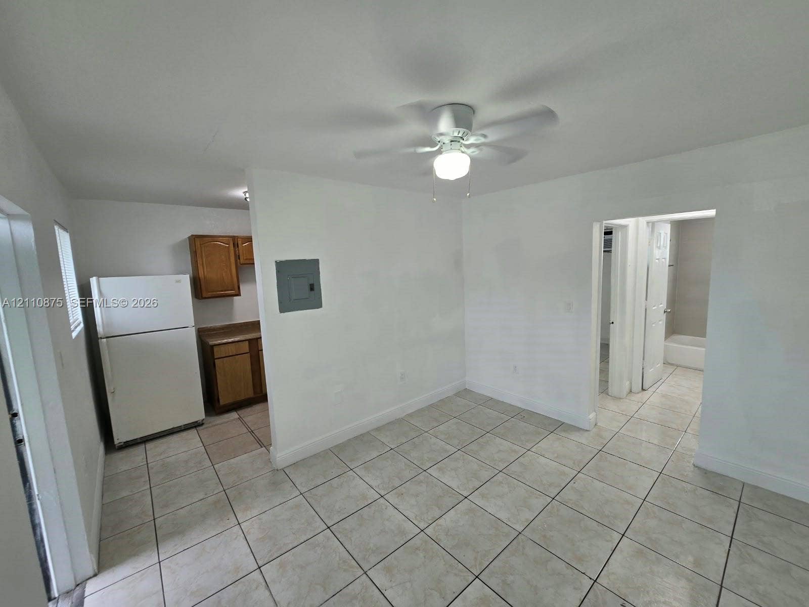 535 NW 7th Street, #10, Miami, Miami, FL 33136 Interior space featuring tile flooring, ceiling fan with integrated lighting, and white cabinetry