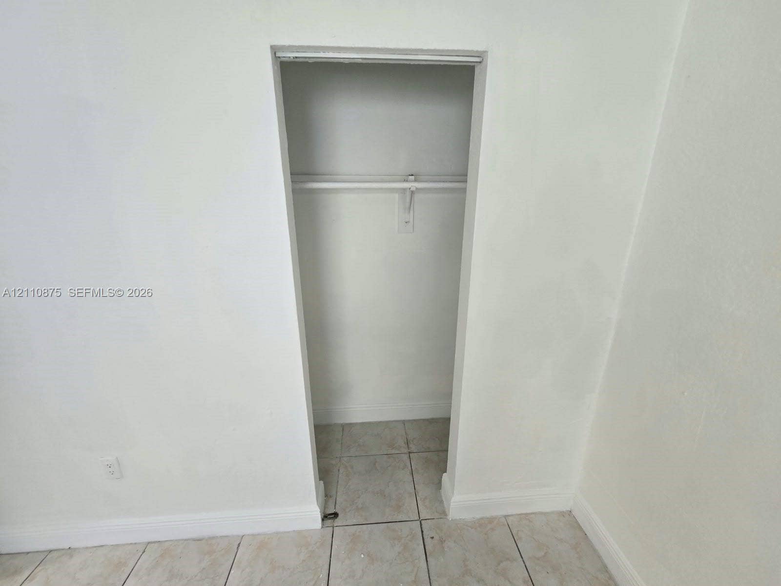 535 NW 7th Street, #10, Miami, Miami, FL 33136 Built-in closet featuring a horizontal hanging rod and ceramic tile flooring