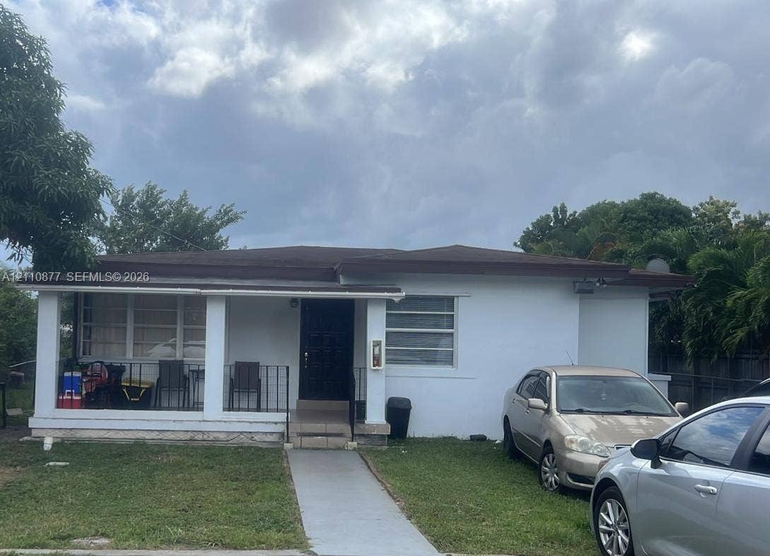 7230 NW 3rd Street, #4, Miami, Miami, FL 33126 Single-story exterior featuring a covered front porch, horizontal siding, and multi-paned windows