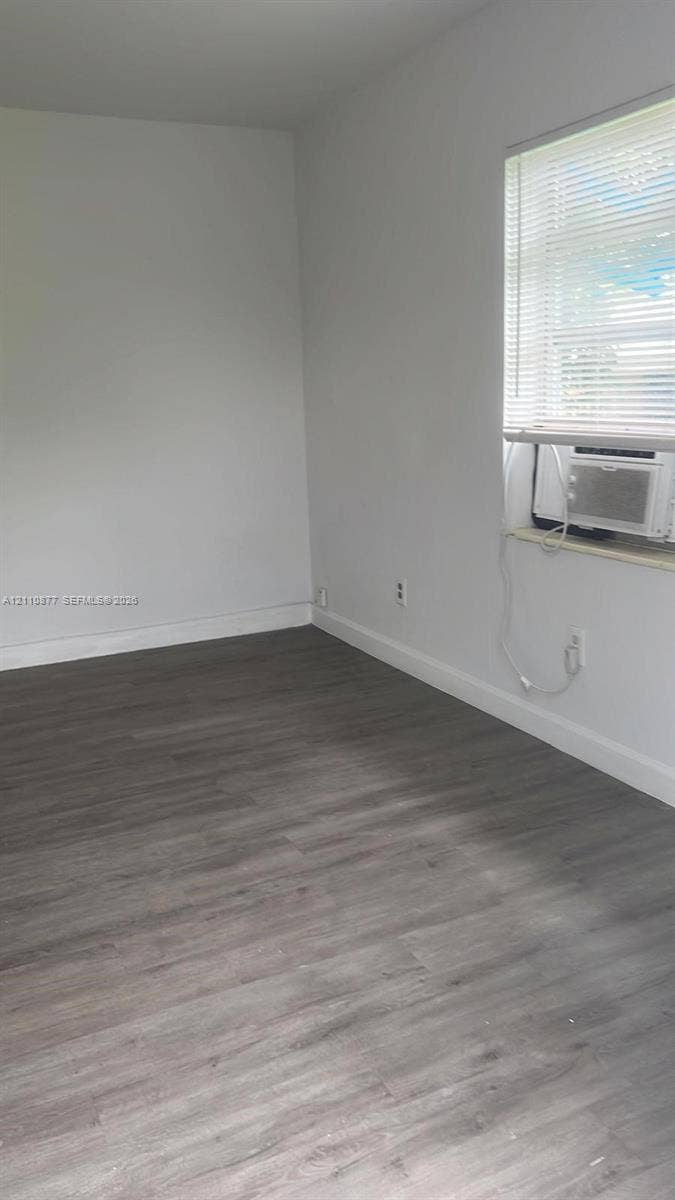7230 NW 3rd Street, #4, Miami, Miami, FL 33126 Neutral wall tones, wood-finish flooring, window with integrated blinds, and built-in wall-mounted air conditioning unit
