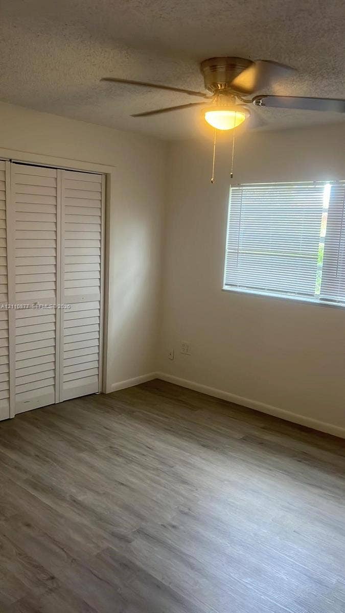 7230 NW 3rd Street, #4, Miami, Miami, FL 33126 Wood-finish flooring, ceiling fan with integrated lighting, window blinds, and dual bi-fold closet doors