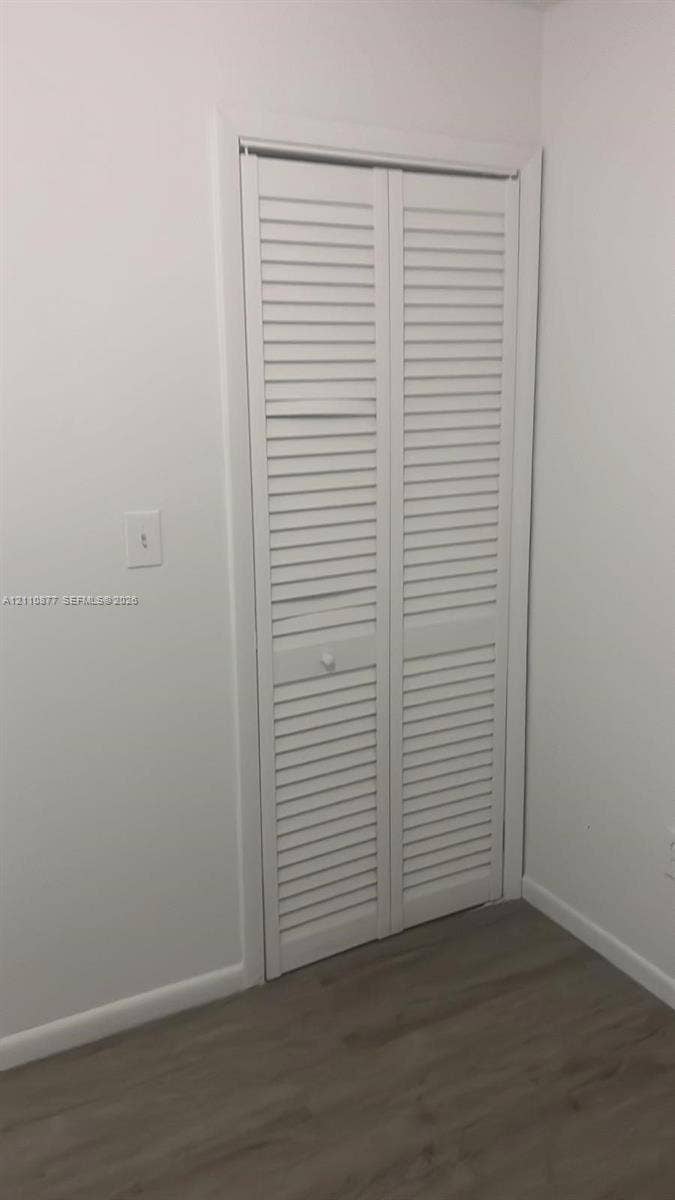 7230 NW 3rd Street, #4, Miami, Miami, FL 33126 White louvered bifold closet doors with wood-finish flooring