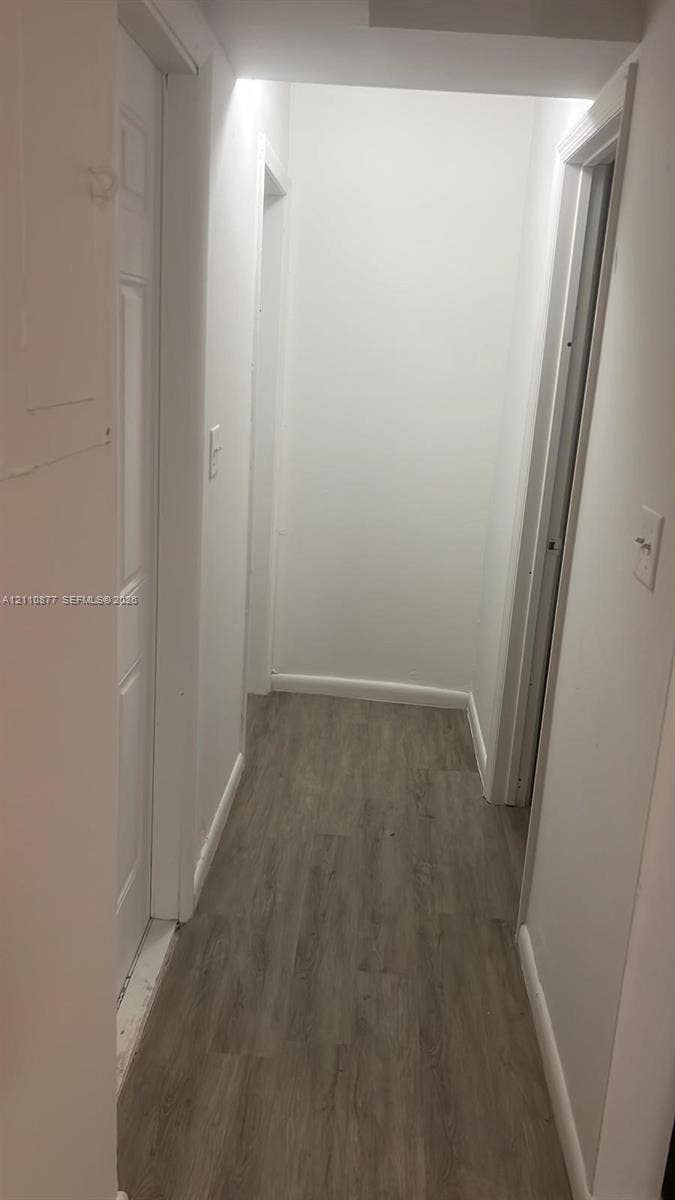 7230 NW 3rd Street, #4, Miami, Miami, FL 33126 Hallway featuring white interior doors and wood-finish flooring