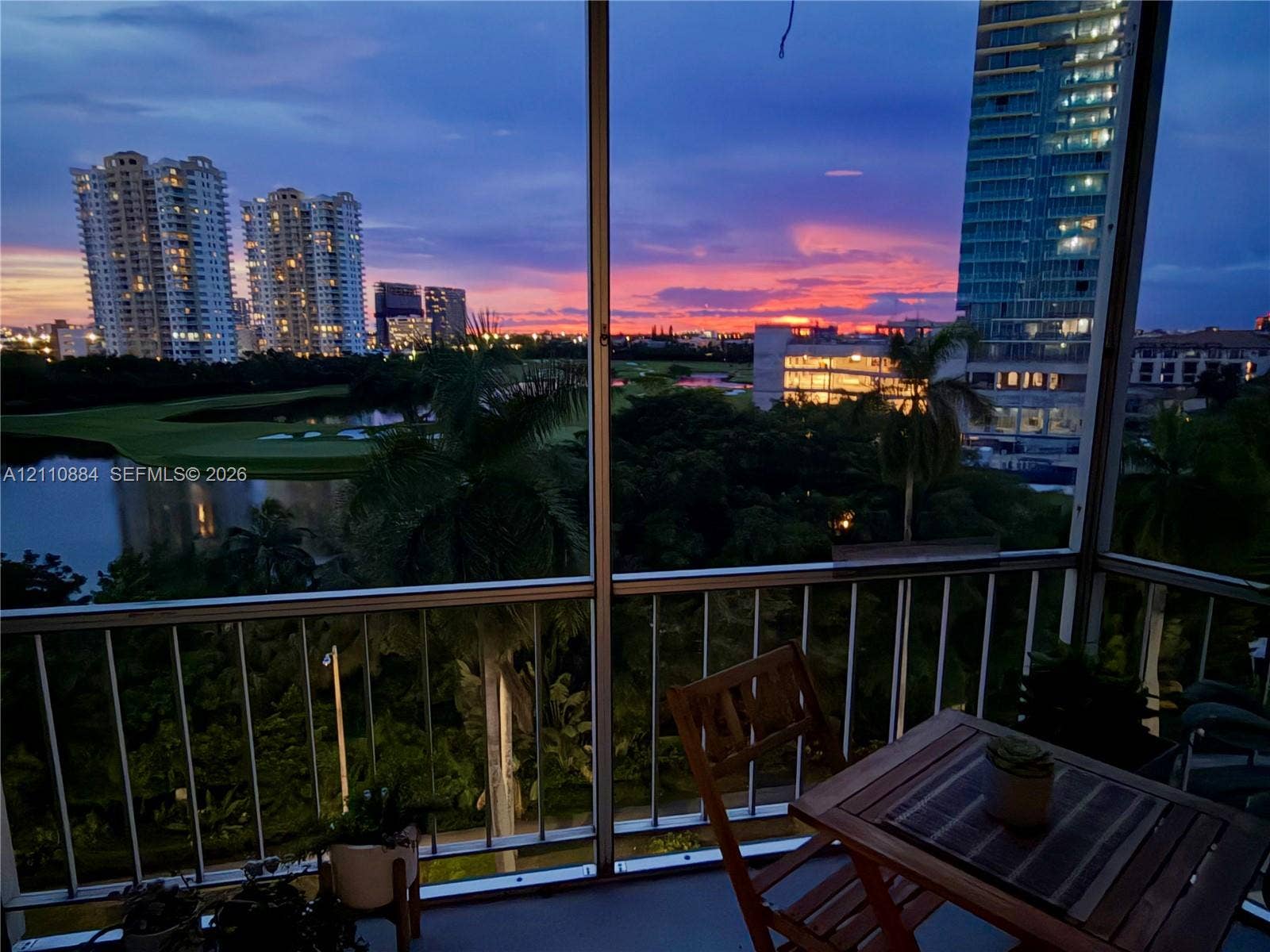 400 Diplomat Parkway, #805, Hallandale Beach, FL 33009 Screened balcony featuring a metal railing and a direct perspective of the landscape, water, and horizon