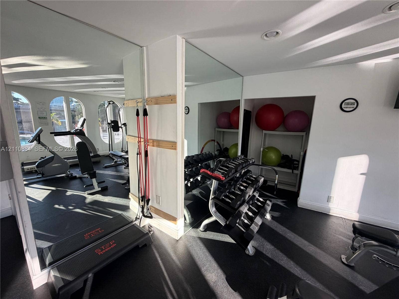 400 Diplomat Parkway, #805, Hallandale Beach, FL 33009 Full-height mirrored walls, resilient flooring, recessed ceiling lighting, and arched window openings