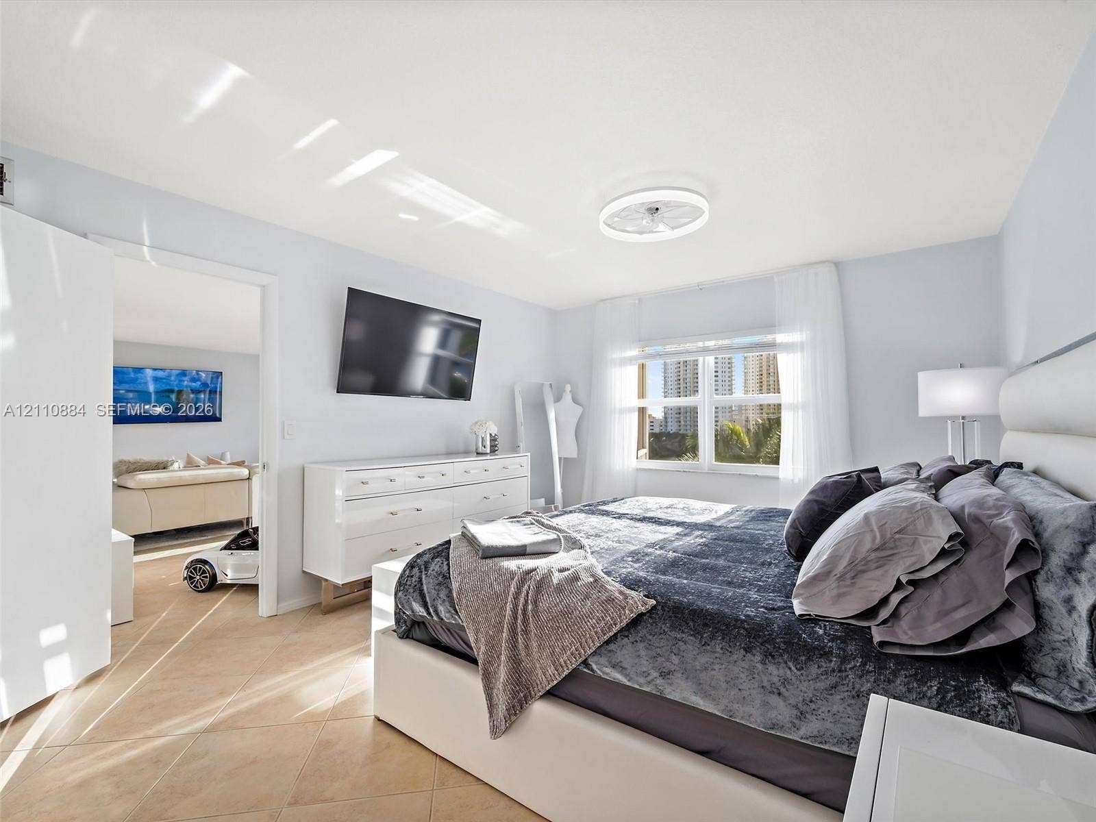 400 Diplomat Parkway, #805, Hallandale Beach, FL 33009 Neutral-toned tile flooring, recessed ceiling lighting with integrated fan, and brand new impact rated oversized window with exterior exposure, water, lake, golf course and tropical oasis views