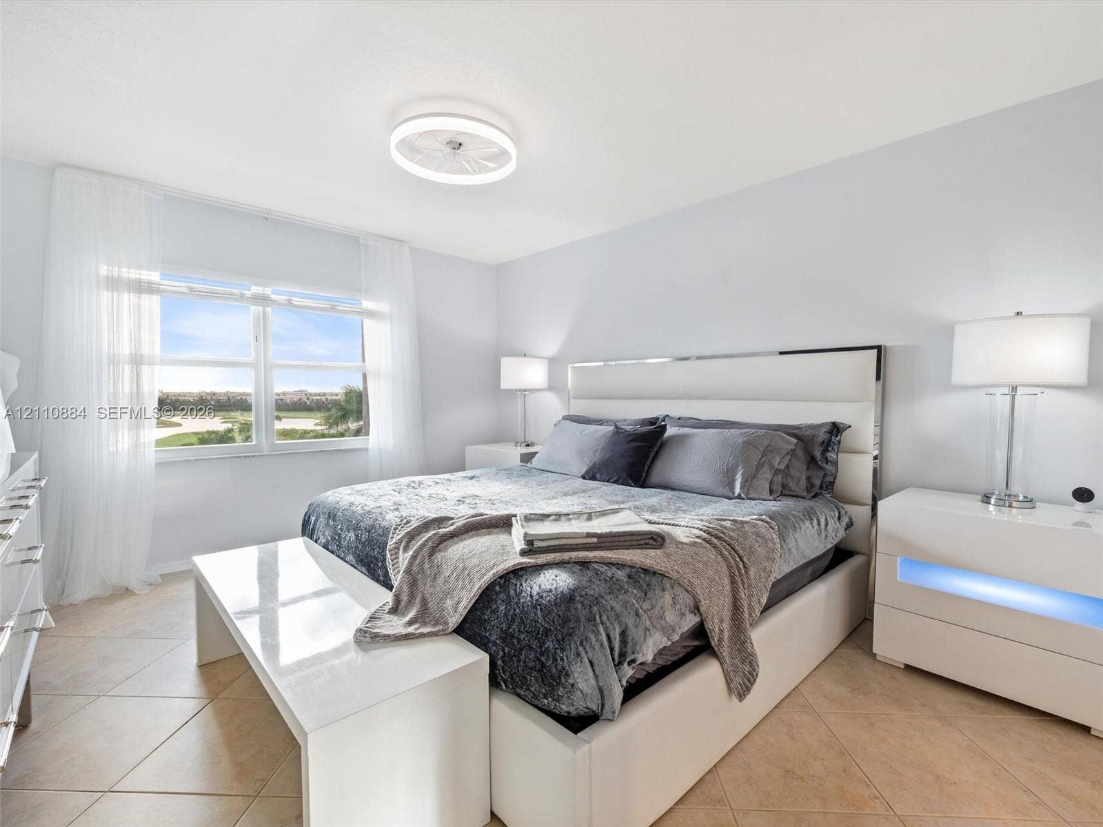 400 Diplomat Parkway, #805, Hallandale Beach, FL 33009 Large-format tile flooring, brand new impact dual-pane windows, and a low-profile dimmable circular LED ceiling fixture and fan combination