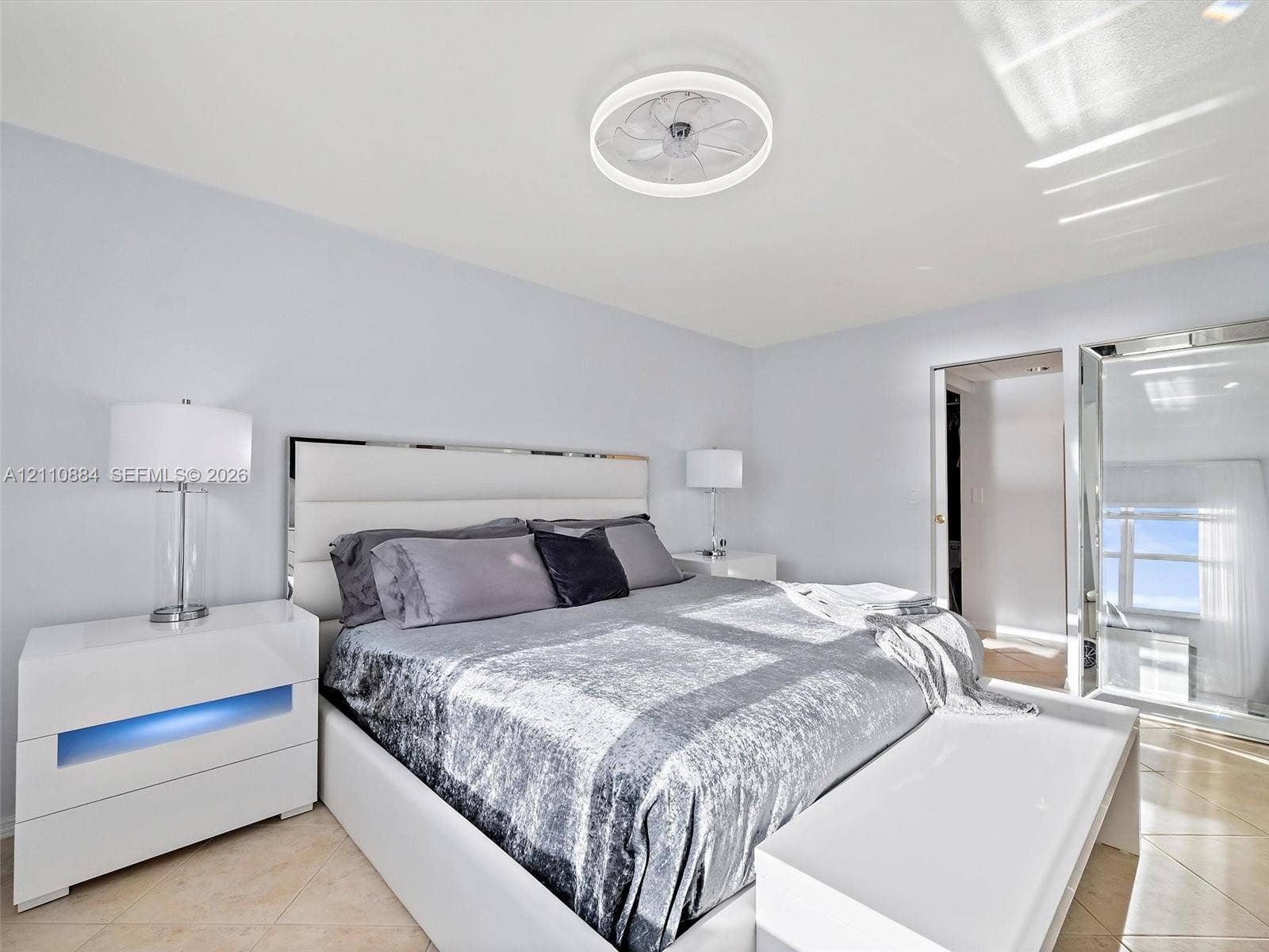 400 Diplomat Parkway, #805, Hallandale Beach, FL 33009 Neutral-toned interior space featuring light-colored tile flooring, smooth walls, and a recessed, circular dimmable LED ceiling light / fan fixture with remote