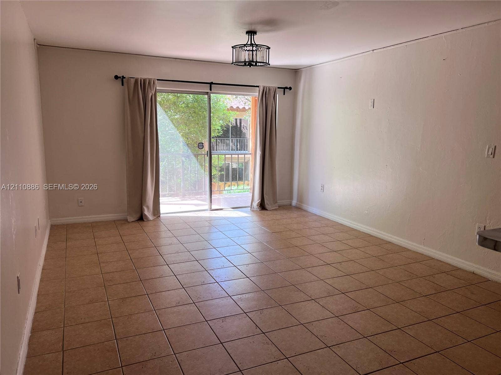7101 Miami Lakes Drive, #Q12, Miami Lakes, Miami Lakes, FL 33014 Shower area featuring large-format stone-look wall tiles and a dark, hexagonal tile floor, paired with a dark-toned vanity cabinet and stone countertop