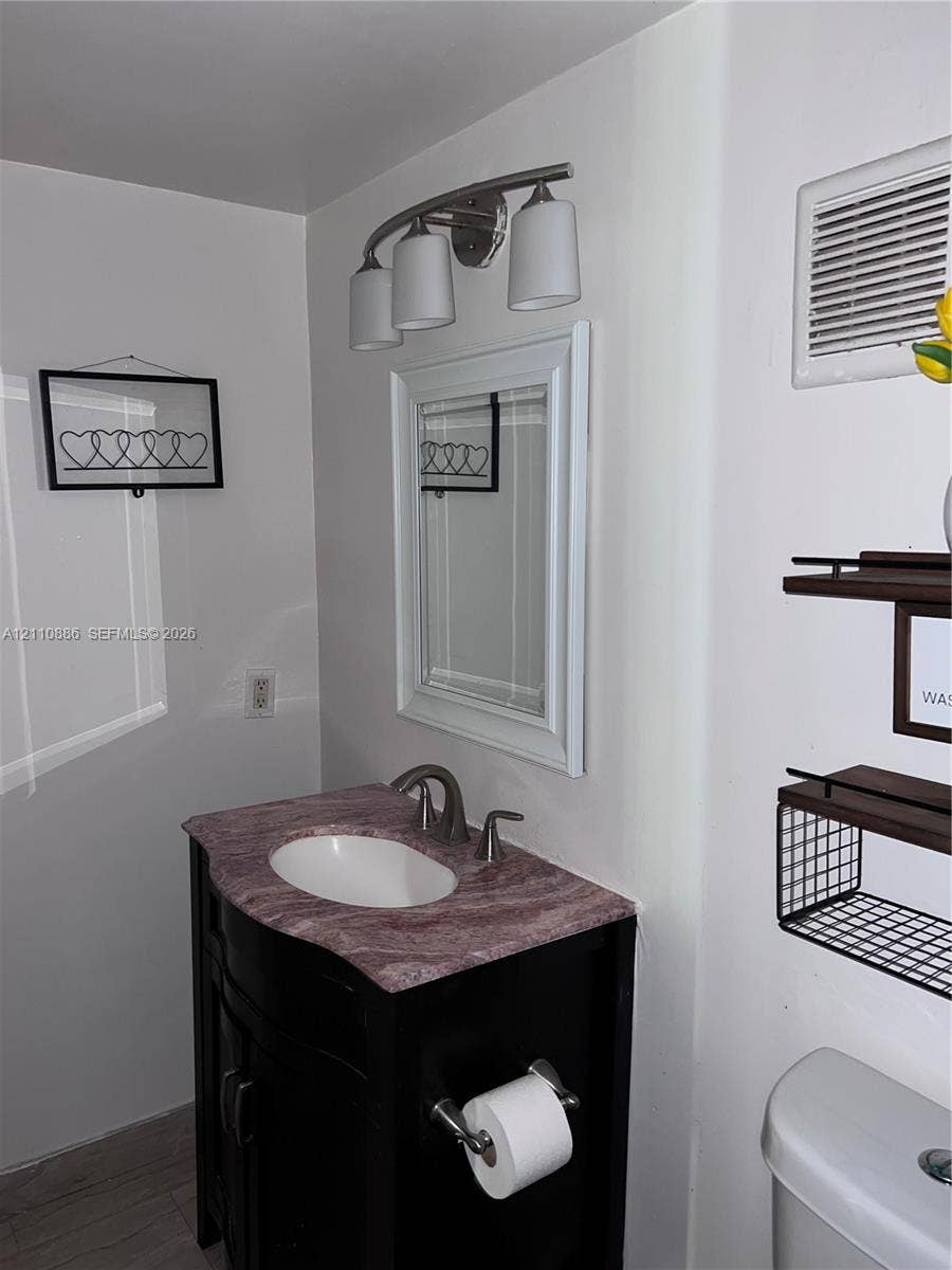 7101 Miami Lakes Drive, #Q12, Miami Lakes, Miami Lakes, FL 33014 Reach-in closet featuring a white louvered door, interior wire shelving, and tile flooring