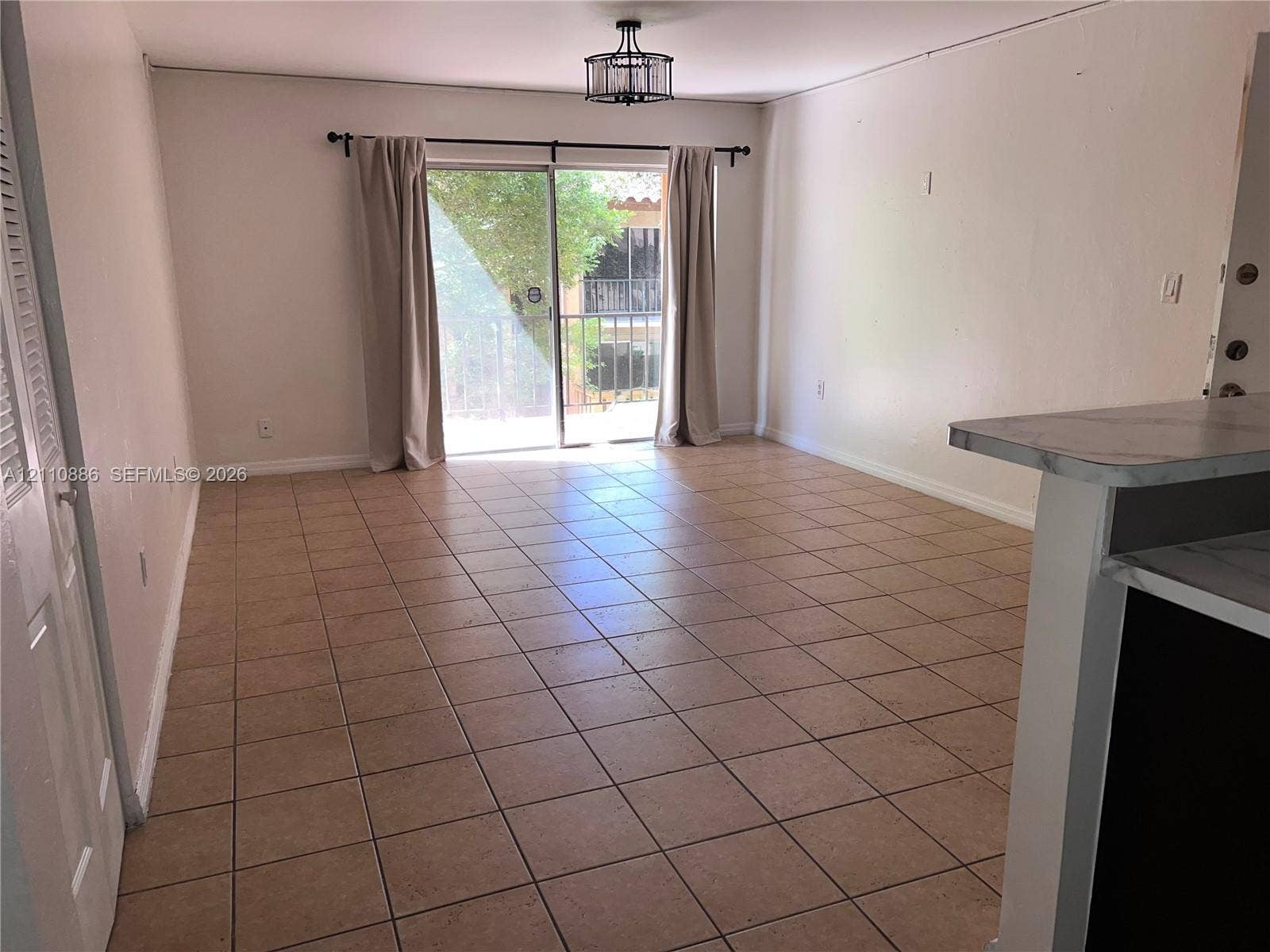 7101 Miami Lakes Drive, #Q12, Miami Lakes, Miami Lakes, FL 33014 Ceramic tile flooring, sliding glass door, and geometric drum-style ceiling light fixture