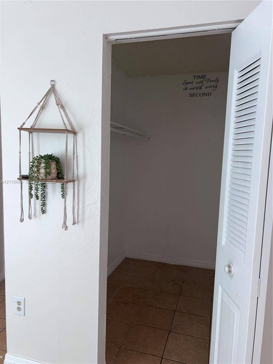 7101 Miami Lakes Drive, #Q12, Miami Lakes, Miami Lakes, FL 33014 Grid-patterned window with exterior ledge, neutral-toned tile flooring, and solid-colored walls