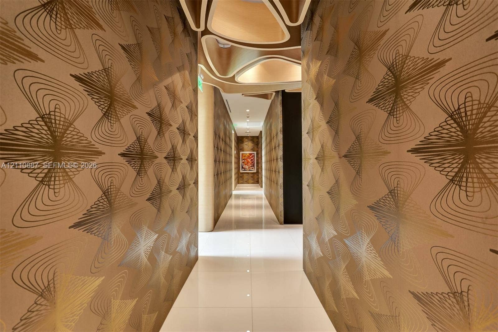 501 NE 31st Street, #4002, Miami, FL 33137 Hallway featuring patterned metallic wall coverings, polished light-toned tile flooring, and custom sculptural geometric ceiling detailing