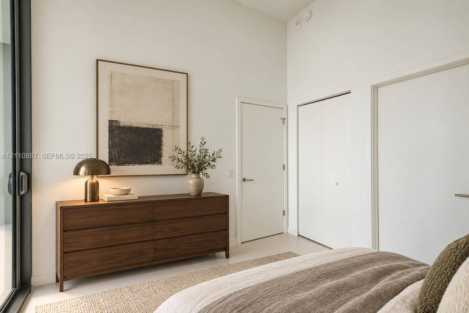 501 NE 31st Street, #4002, Miami, FL 33137 High ceilings, floor-to-ceiling glass sliding door, and neutral interior finishes