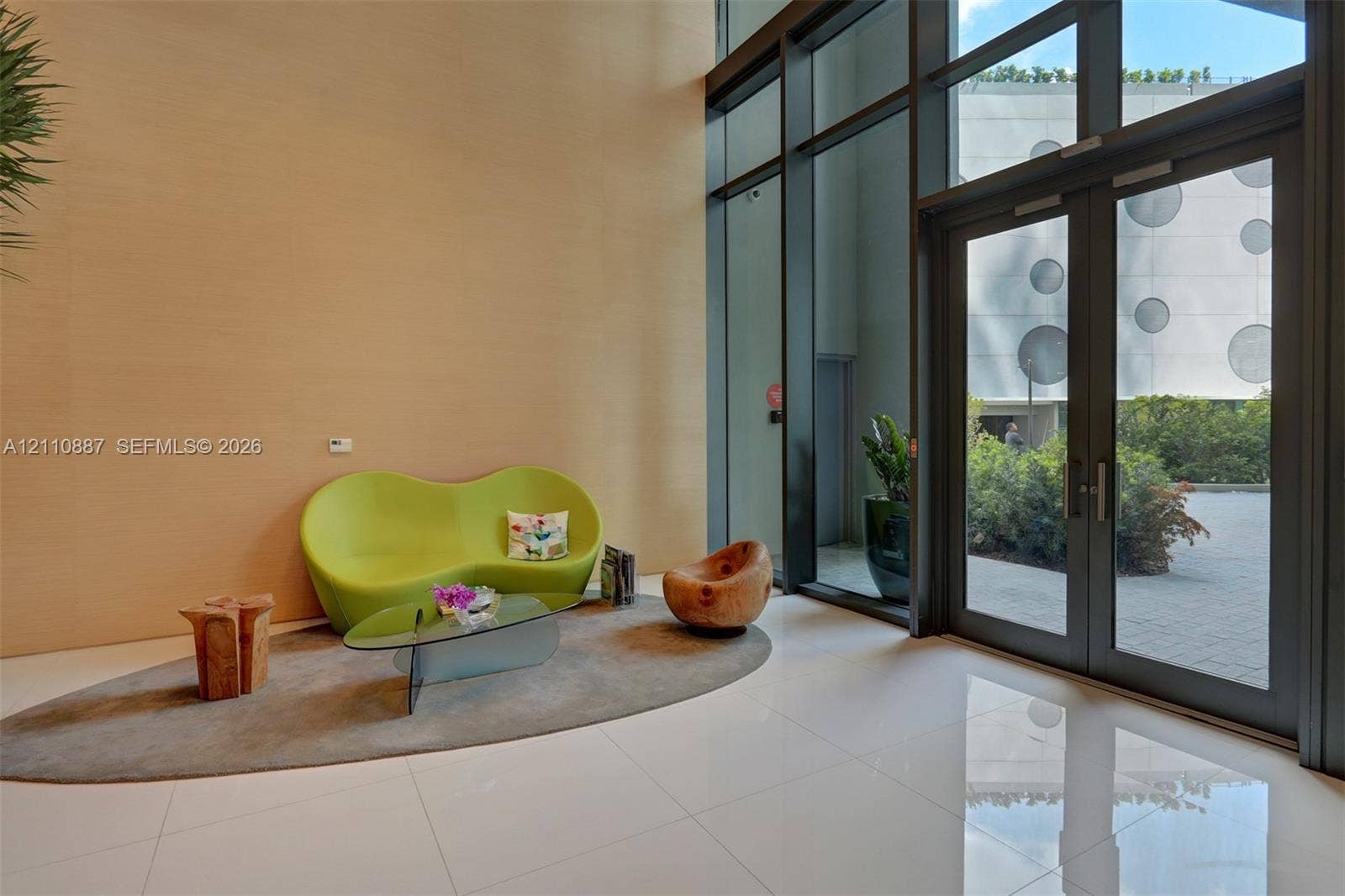 501 NE 31st Street, #4002, Miami, FL 33137 Double-height entryway featuring floor-to-ceiling glass paneling, full-height double door entry, and polished large-format tile flooring