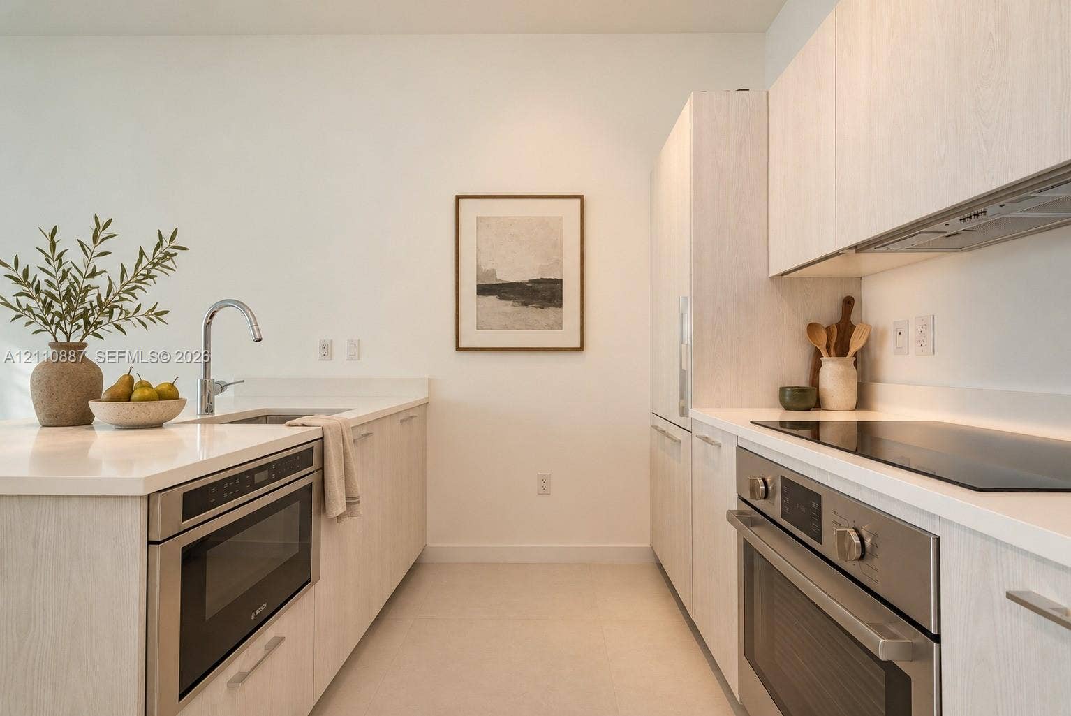 501 NE 31st Street, #4002, Miami, FL 33137 Kitchen featuring light-finish cabinetry, solid-surface countertops, stainless steel wall oven, flat-surface cooktop, and built-in microwave