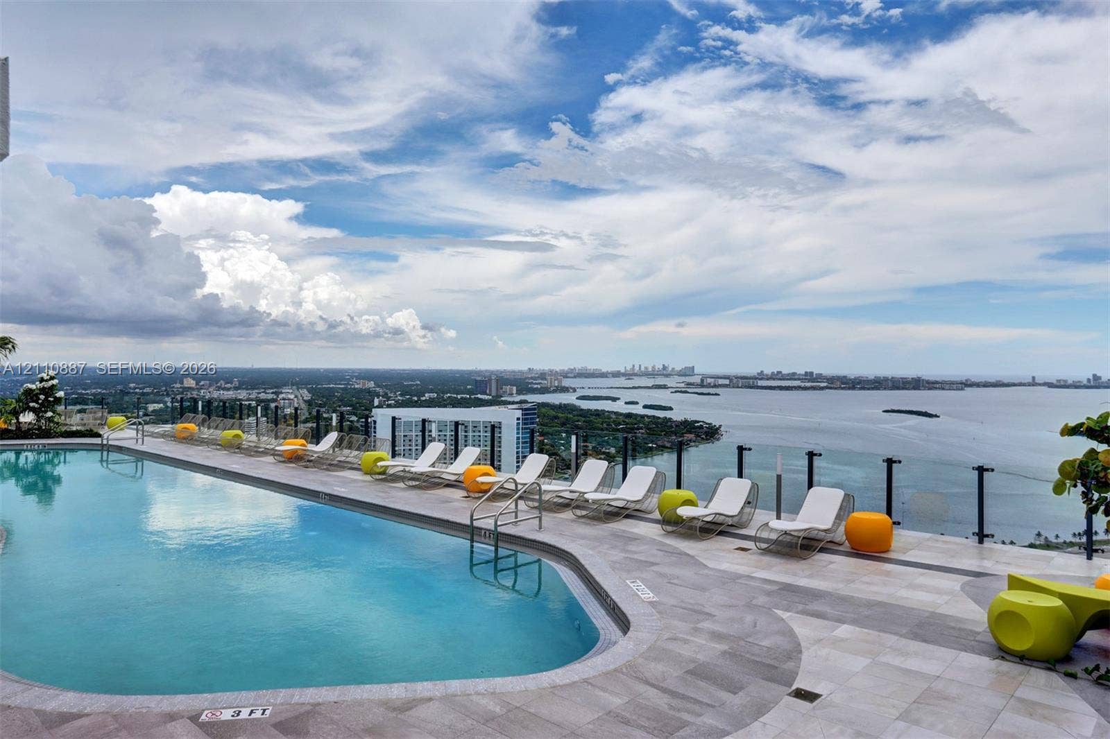 501 NE 31st Street, #4002, Miami, FL 33137 Rooftop swimming pool with stone-tiled decking and glass panel railing