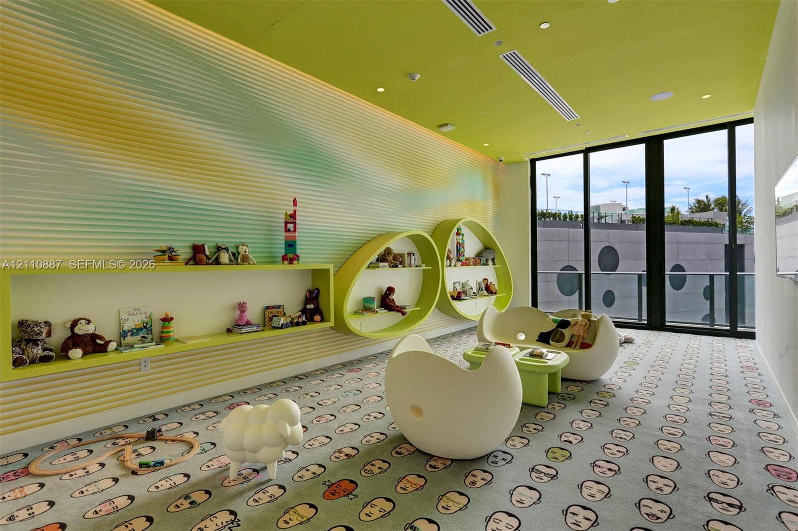 501 NE 31st Street, #4002, Miami, FL 33137 Custom interior space featuring large floor-to-ceiling windows, built-in oval and rectangular shelving, and recessed ceiling lighting