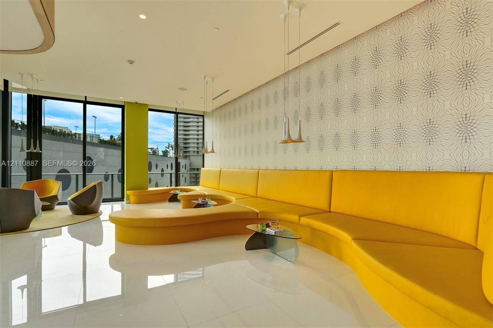 501 NE 31st Street, #4002, Miami, FL 33137 Floor-to-ceiling glass windows, built-in curvilinear banquette seating, polished tile flooring, recessed ceiling lighting, and pendant fixtures