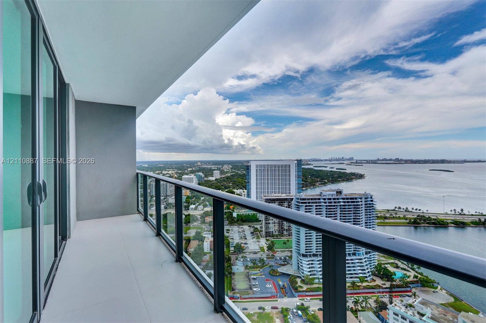 501 NE 31st Street, #4002, Miami, FL 33137 Covered balcony with a glass-panel railing and large-format tile flooring