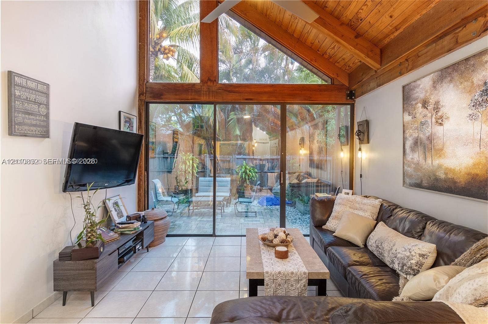 497 N University Drive, #2-7, Plantation, FL 33324 Vaulted ceiling with exposed wood beams, full-height windows, and expansive sliding glass doors