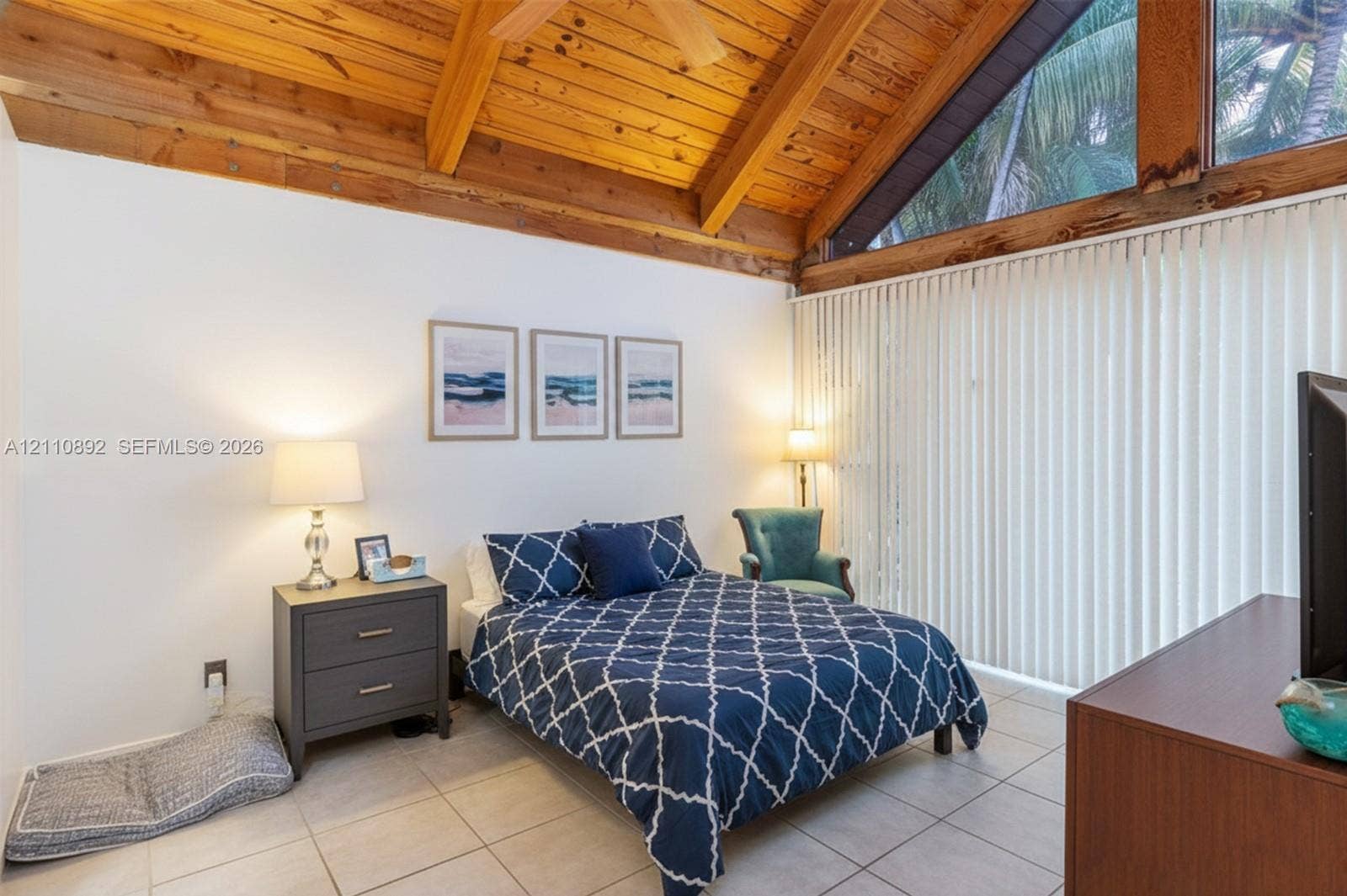 497 N University Drive, #2-7, Plantation, FL 33324 Vaulted wood-plank ceiling with exposed beams, expansive triangular clerestory windows, and large-format tile flooring