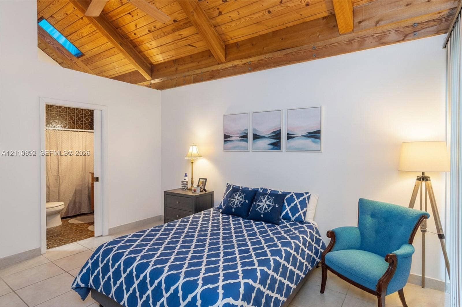 497 N University Drive, #2-7, Plantation, FL 33324 Vaulted wood-plank ceiling with exposed beams, skylight, and large-format tile flooring