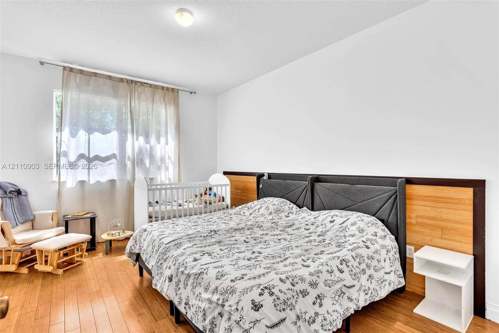 Wood-finish flooring and integrated horizontal wood-paneled accent wall with built-in side shelving