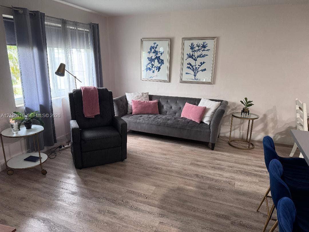 Wood-finish flooring and large windows with integrated curtain rods