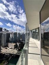 Covered balcony featuring glass paneled railings, concrete flooring, and floor-to-ceiling glass wall enclosures
