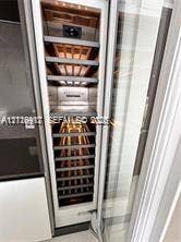 Built-in full-height wine refrigerator featuring a glass door, metal shelving, and digital temperature control