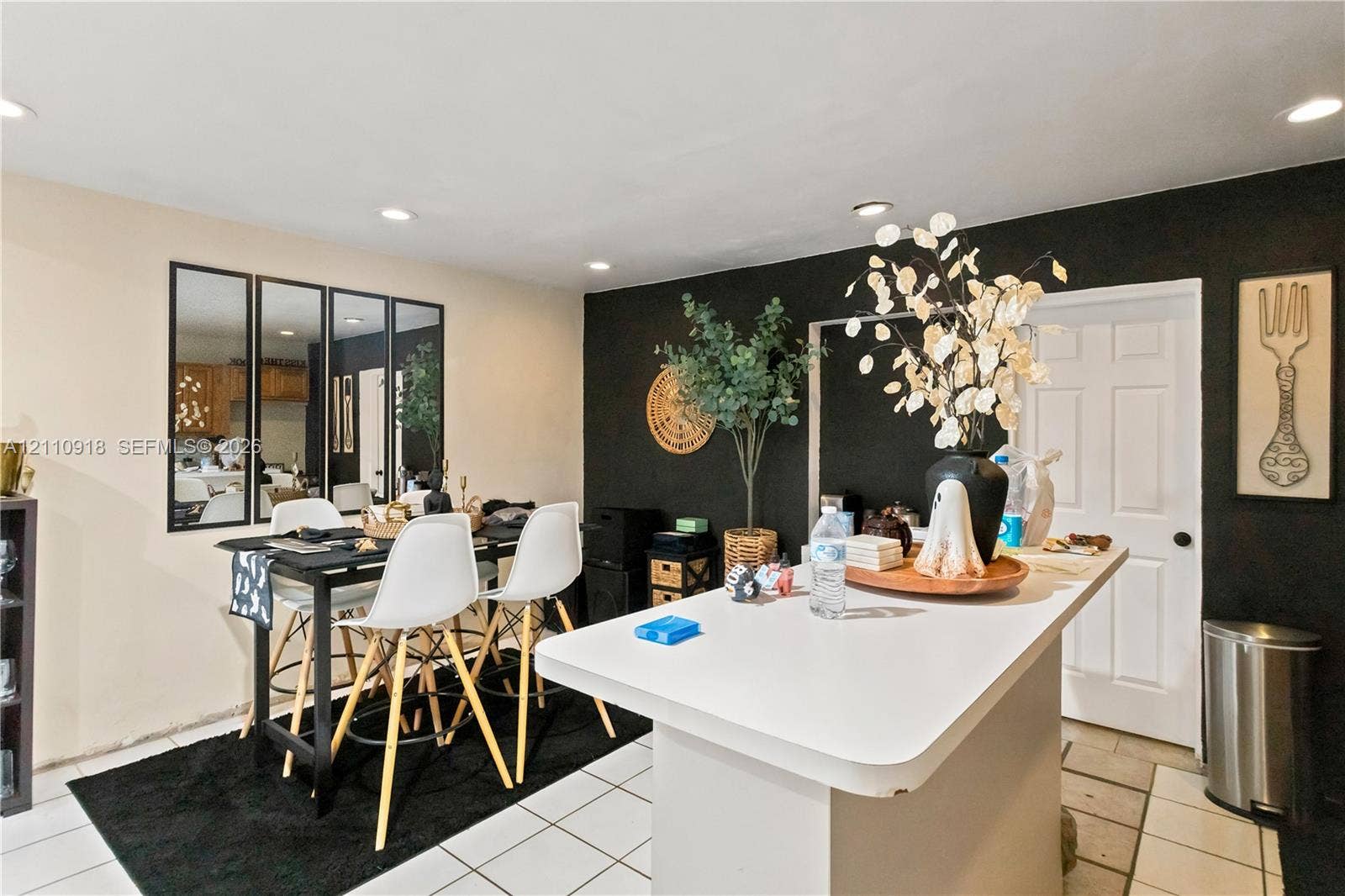 2007 NW 89th Street, Miami, FL 33147 Solid-surface countertop island, recessed ceiling lighting, wall-mounted multi-panel mirror, and tile flooring