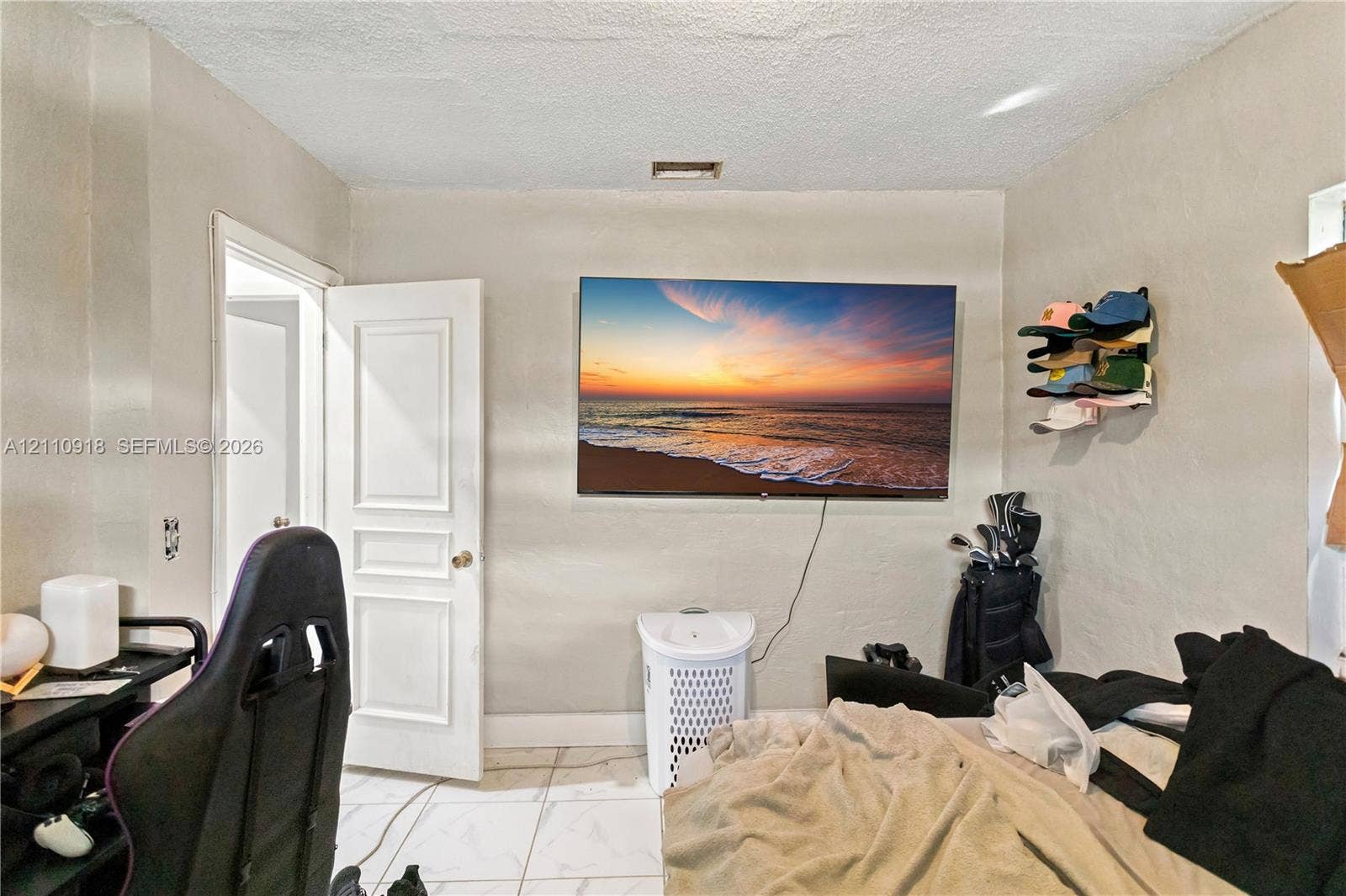2007 NW 89th Street, Miami, FL 33147 Neutral-toned interior space featuring tile flooring and a white paneled door