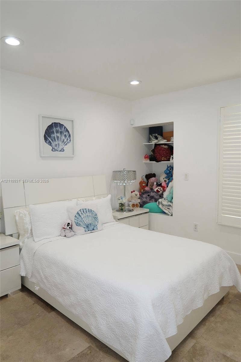 3005 SW 99th Court, Miami, FL 33165 Neutral-toned tile flooring, built-in recessed shelving, integrated ceiling lighting, and plantation-style window shutters