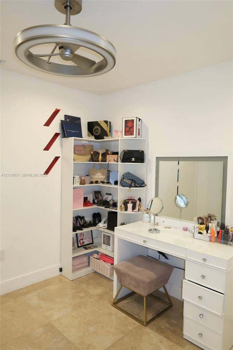 3005 SW 99th Court, Miami, FL 33165 Modern brushed-nickel ceiling fan with integrated LED circular lighting, polished stone flooring, and recessed corner shelving