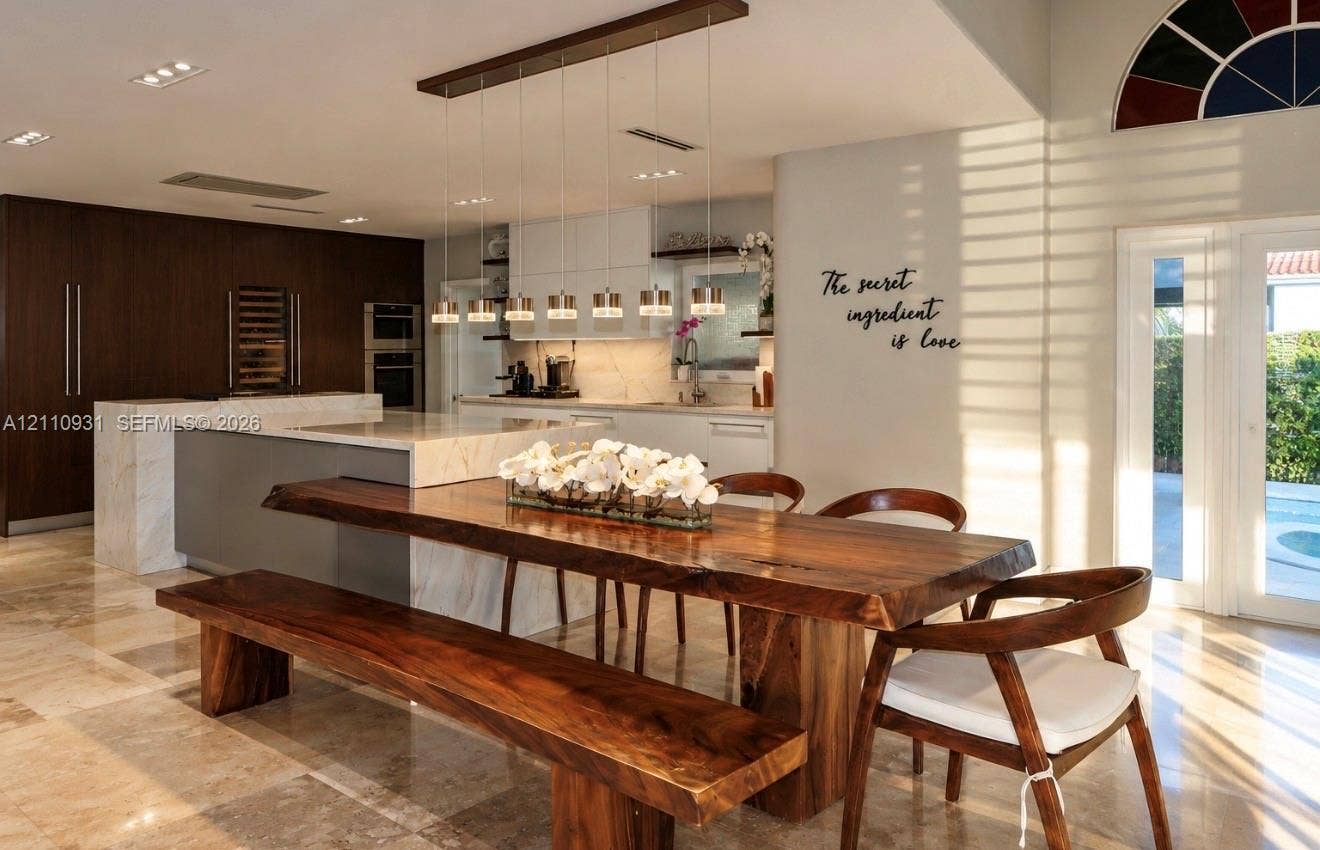 3005 SW 99th Court, Miami, FL 33165 Kitchen featuring a stone-surface island, dark-toned cabinetry, recessed ceiling lighting, multi-pendant light fixture, and polished stone flooring