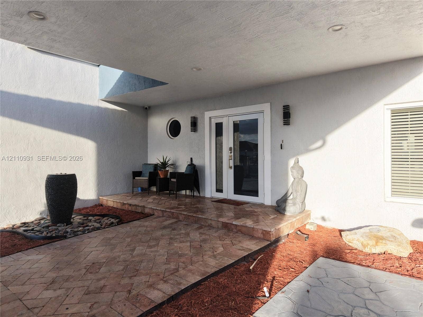 3005 SW 99th Court, Miami, FL 33165 Covered entryway featuring herringbone-pattern tile flooring, double-door entry, recessed lighting, and a circular accent window