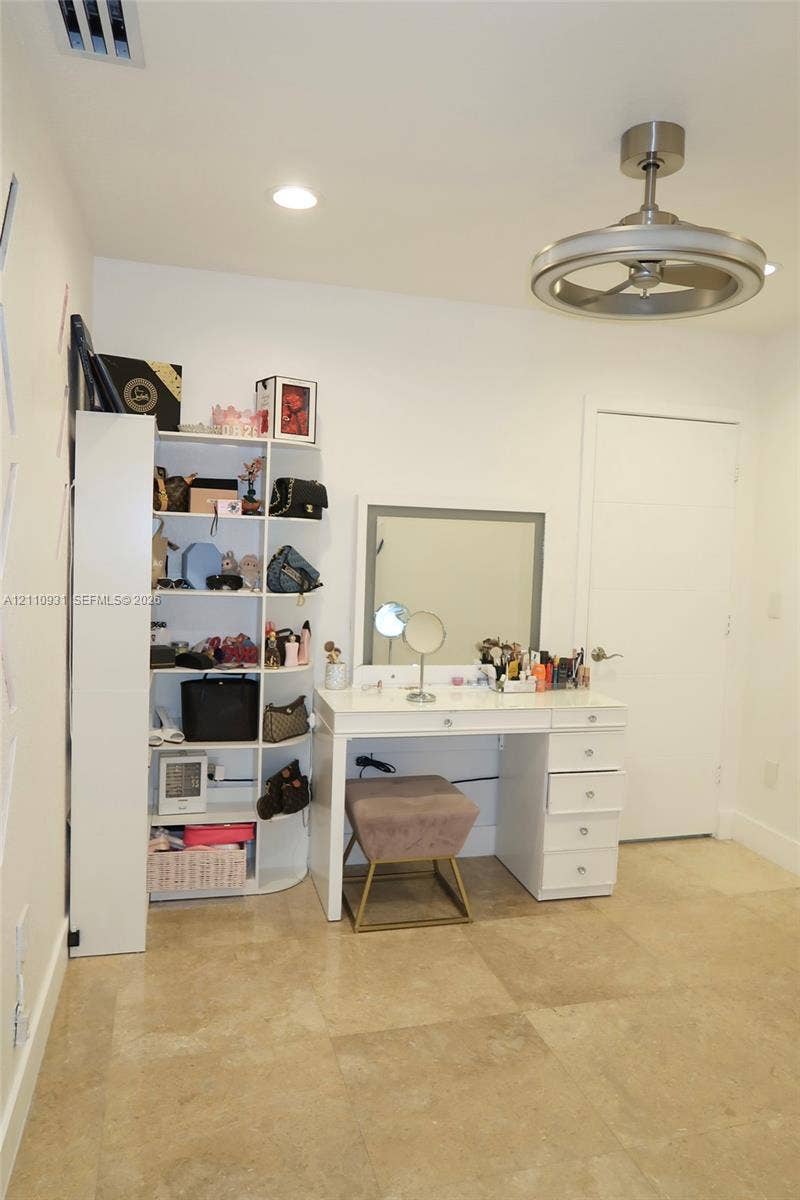 3005 SW 99th Court, Miami, FL 33165 Large-format stone tile flooring, recessed ceiling lighting, and a modern brushed-metal ceiling fan with an integrated circular light fixture