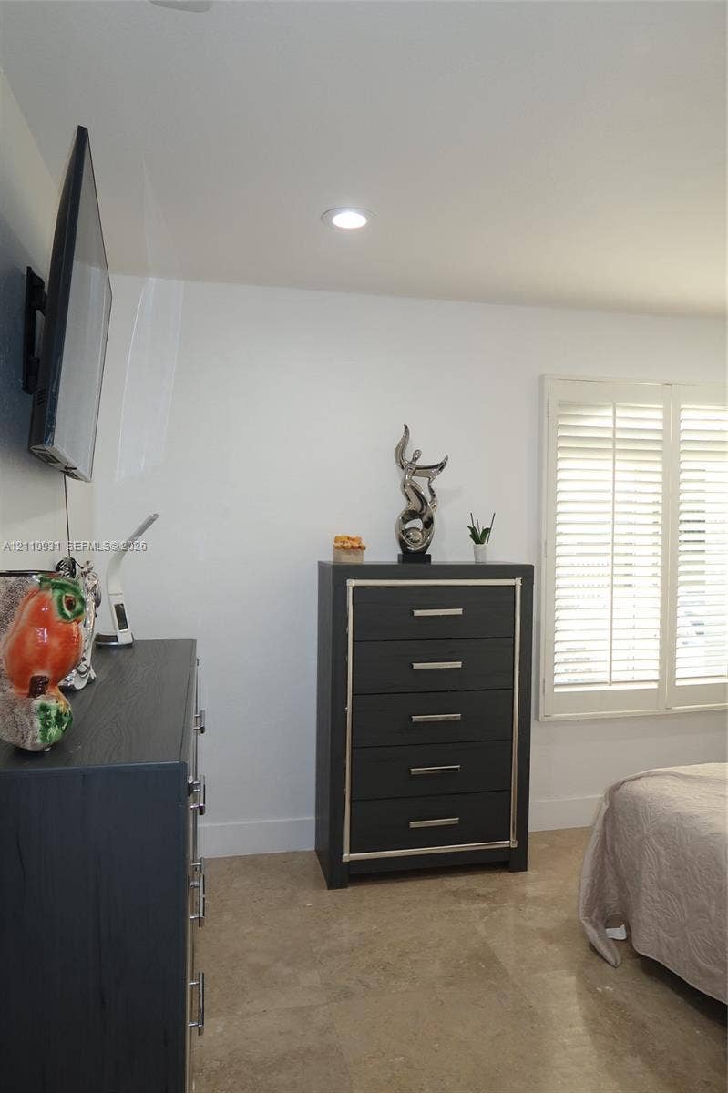 3005 SW 99th Court, Miami, FL 33165 Neutral-toned stone flooring, recessed ceiling lighting, and plantation-style window shutters