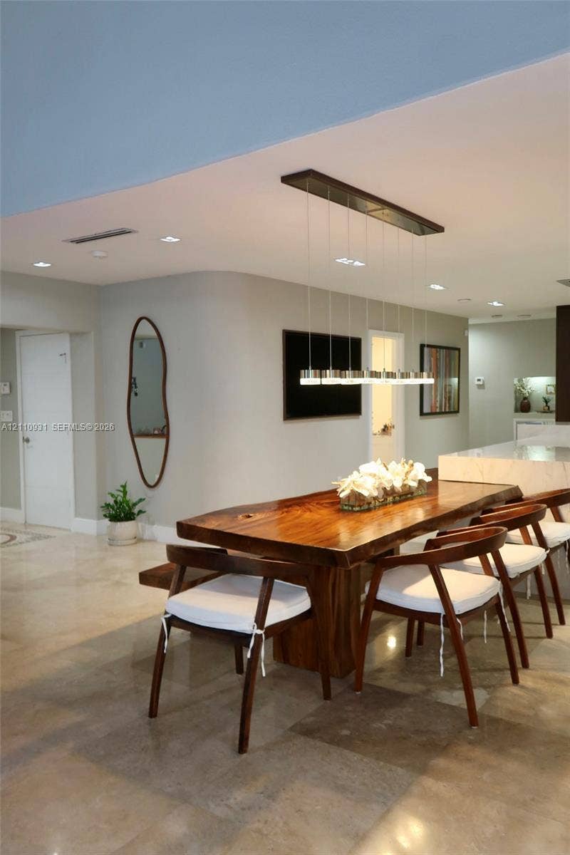 3005 SW 99th Court, Miami, FL 33165 Curved architectural wall detail, polished stone flooring, and contemporary linear multi-pendant lighting fixture