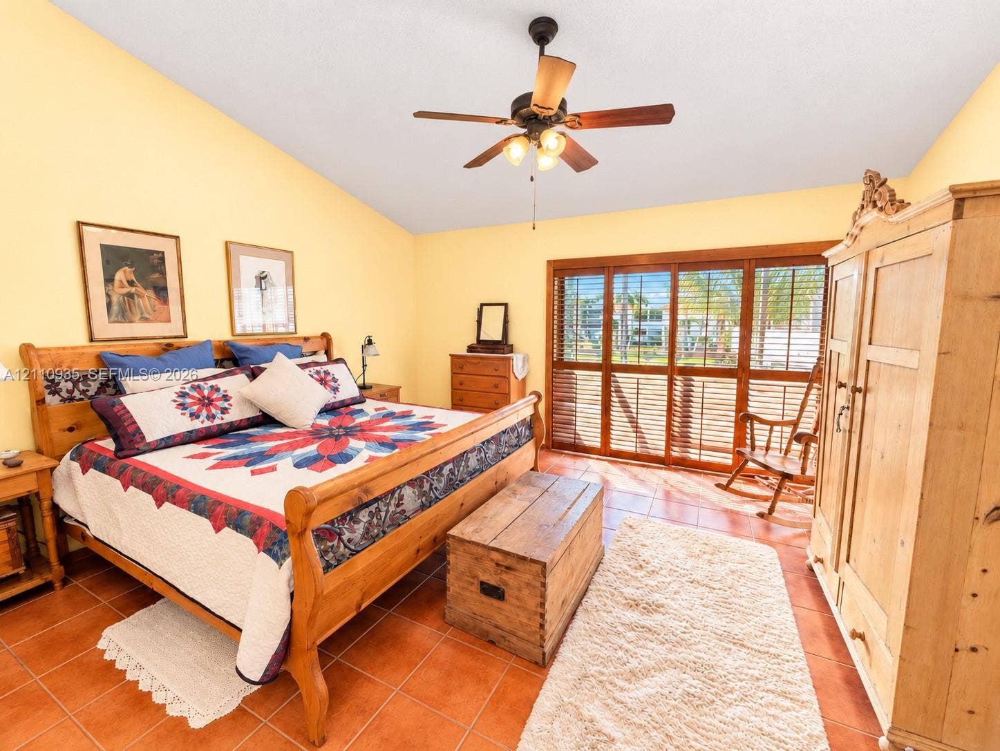 3530 Magellan Circle, #618, Aventura, FL 33180 Vaulted ceiling, ceiling fan with integrated lighting, tile flooring, and floor-to-ceiling sliding glass doors with wood trim