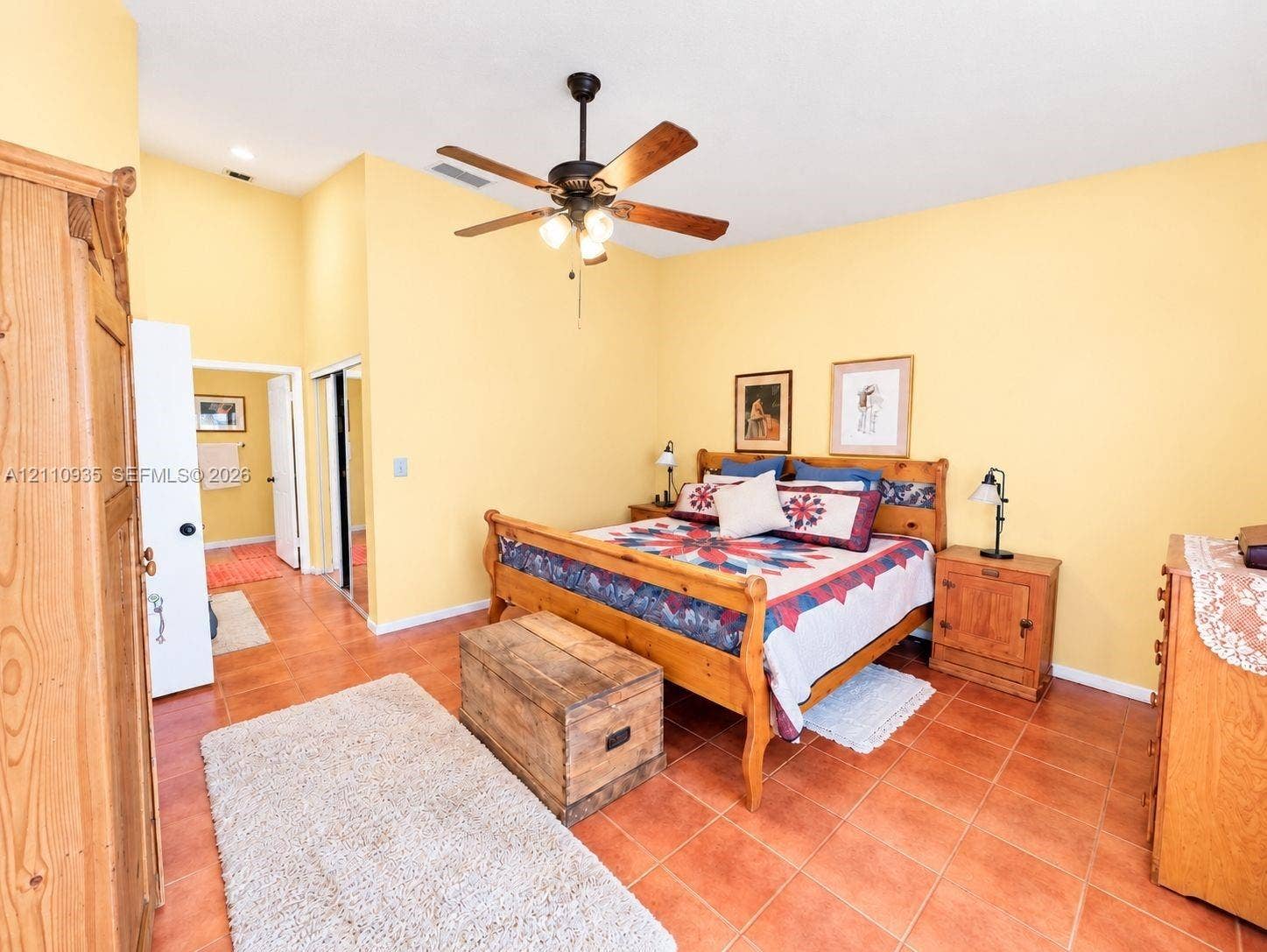 3530 Magellan Circle, #618, Aventura, FL 33180 Spacious room featuring high ceilings, square ceramic tile flooring, a multi-blade ceiling fan with integrated lighting, and mirrored closet doors