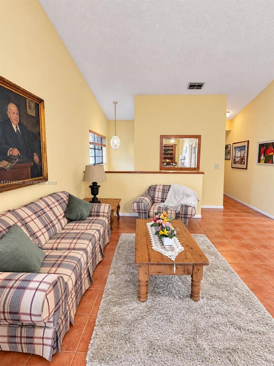 3530 Magellan Circle, #618, Aventura, FL 33180 Vaulted ceilings, terracotta-style flooring, half-wall partition, and geometric pendant lighting
