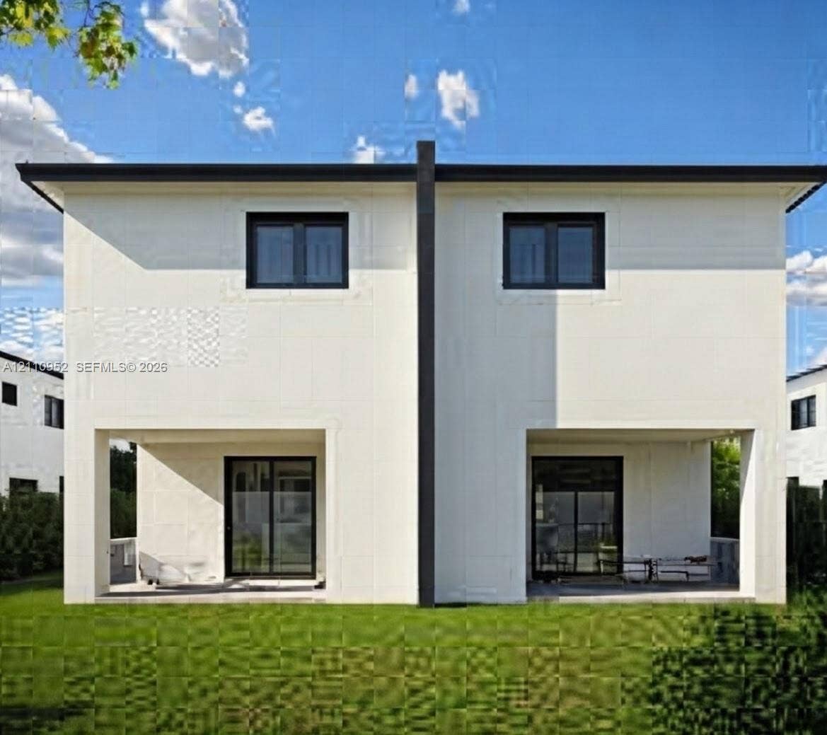 1225 NW 9 Avenue, #0, Florida City, Florida City, FL 33034 Two-story duplex exterior featuring smooth-finish light-colored cladding, dual ground-level covered patios, dark-framed sliding glass doors, and dark-framed windows