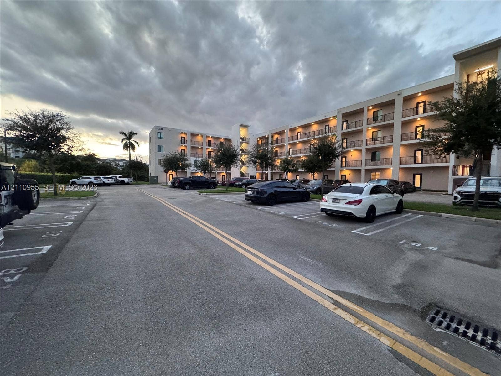 4636 NW 84th Avenue, #35, Doral, FL 33166 Multi-story residential building exterior featuring concrete facade, private recessed balconies, and paved surface parking