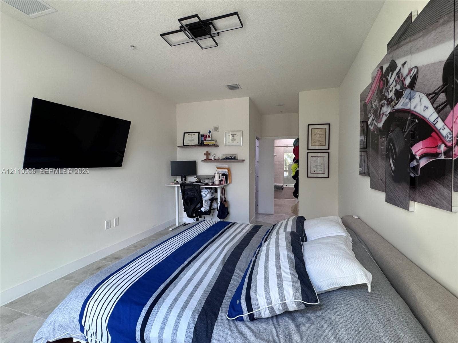 4636 NW 84th Avenue, #35, Doral, FL 33166 Room featuring neutral wall finishes, tile flooring, and a modern geometric flush-mount light fixture