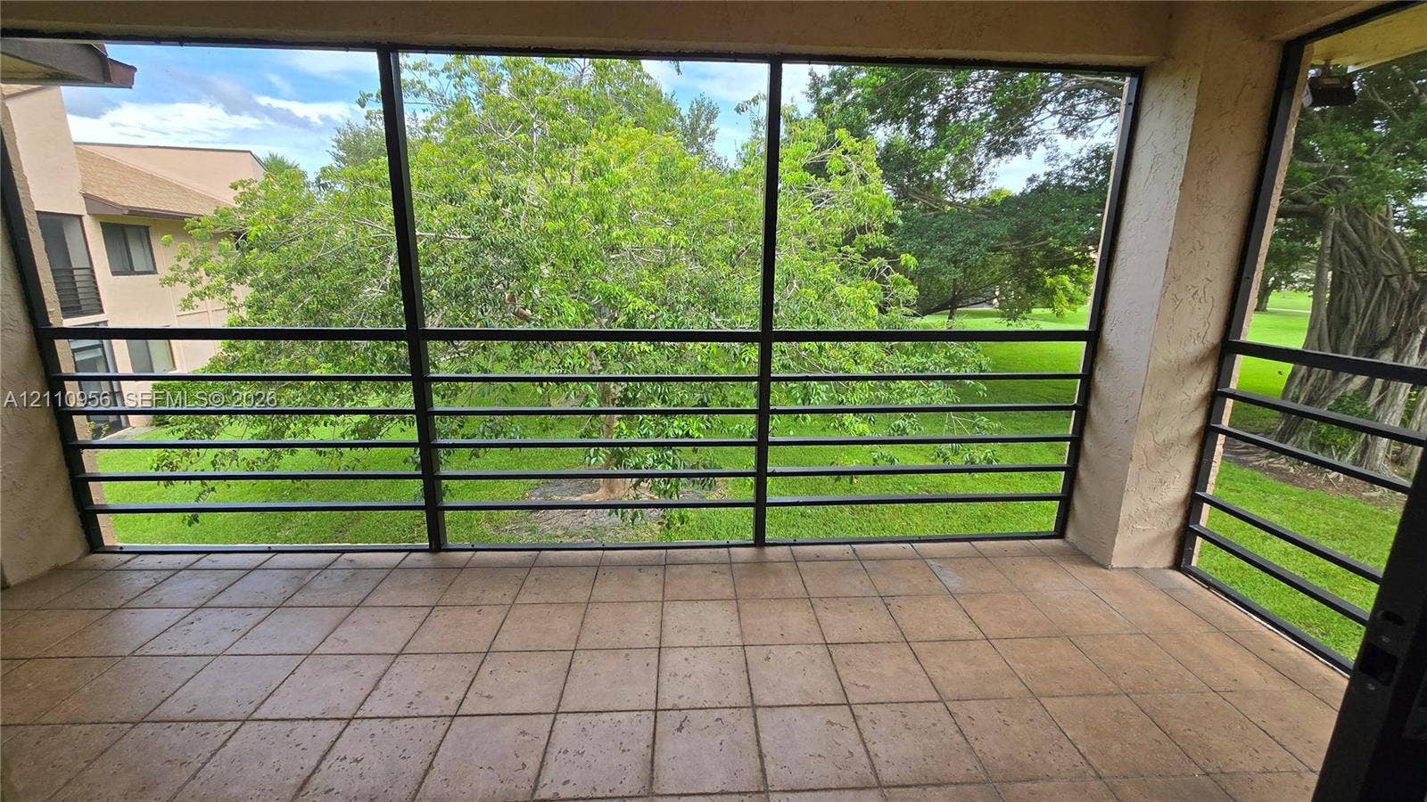 2120 SW 94th Terrace, #404, Davie, FL 33324 Screened-in balcony with tile flooring and black metal framing